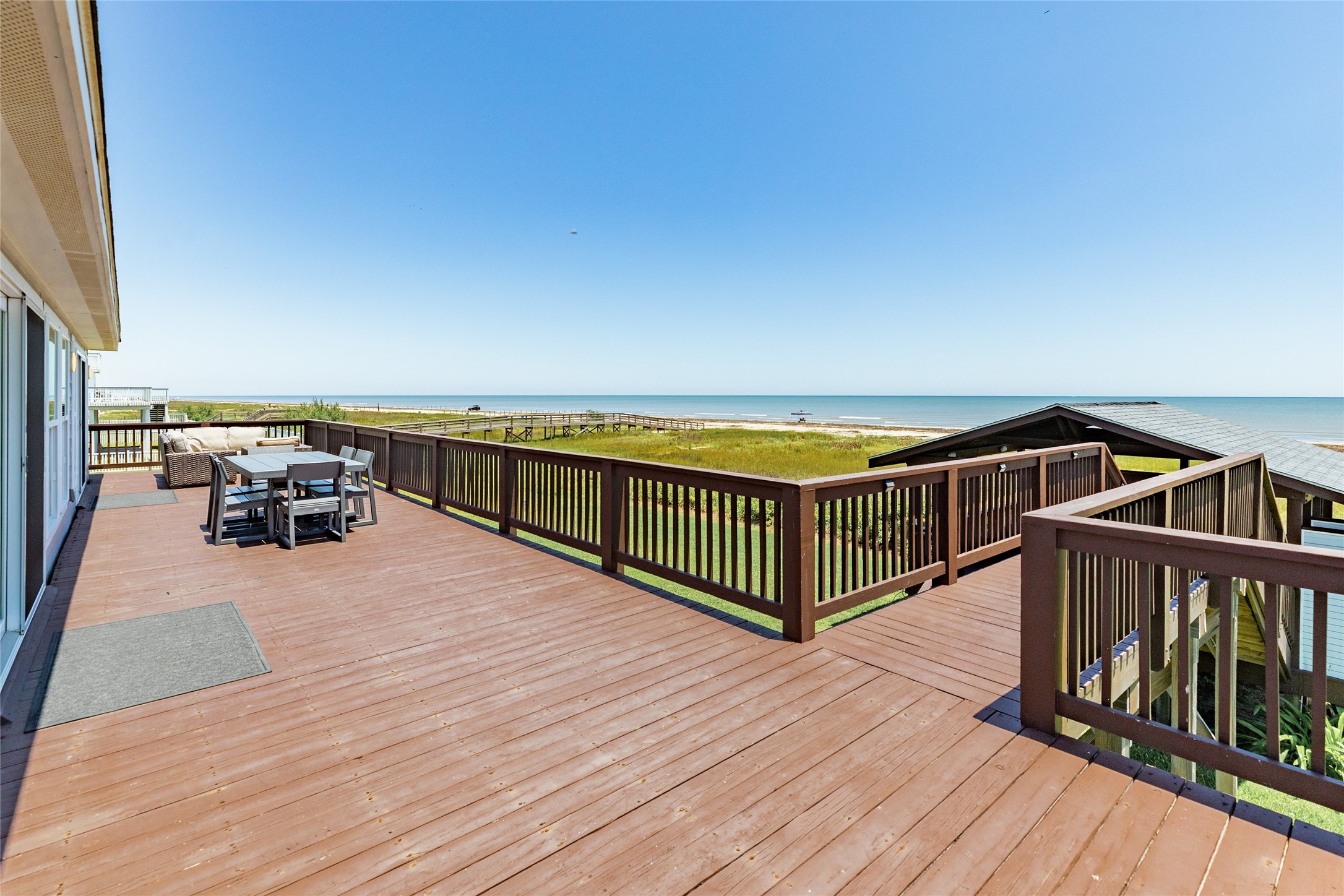 23331 Termini-San Luis Pass Road Galveston, TX 77554 - Photo 1 of 28 a balcony with furniture and wooden floor