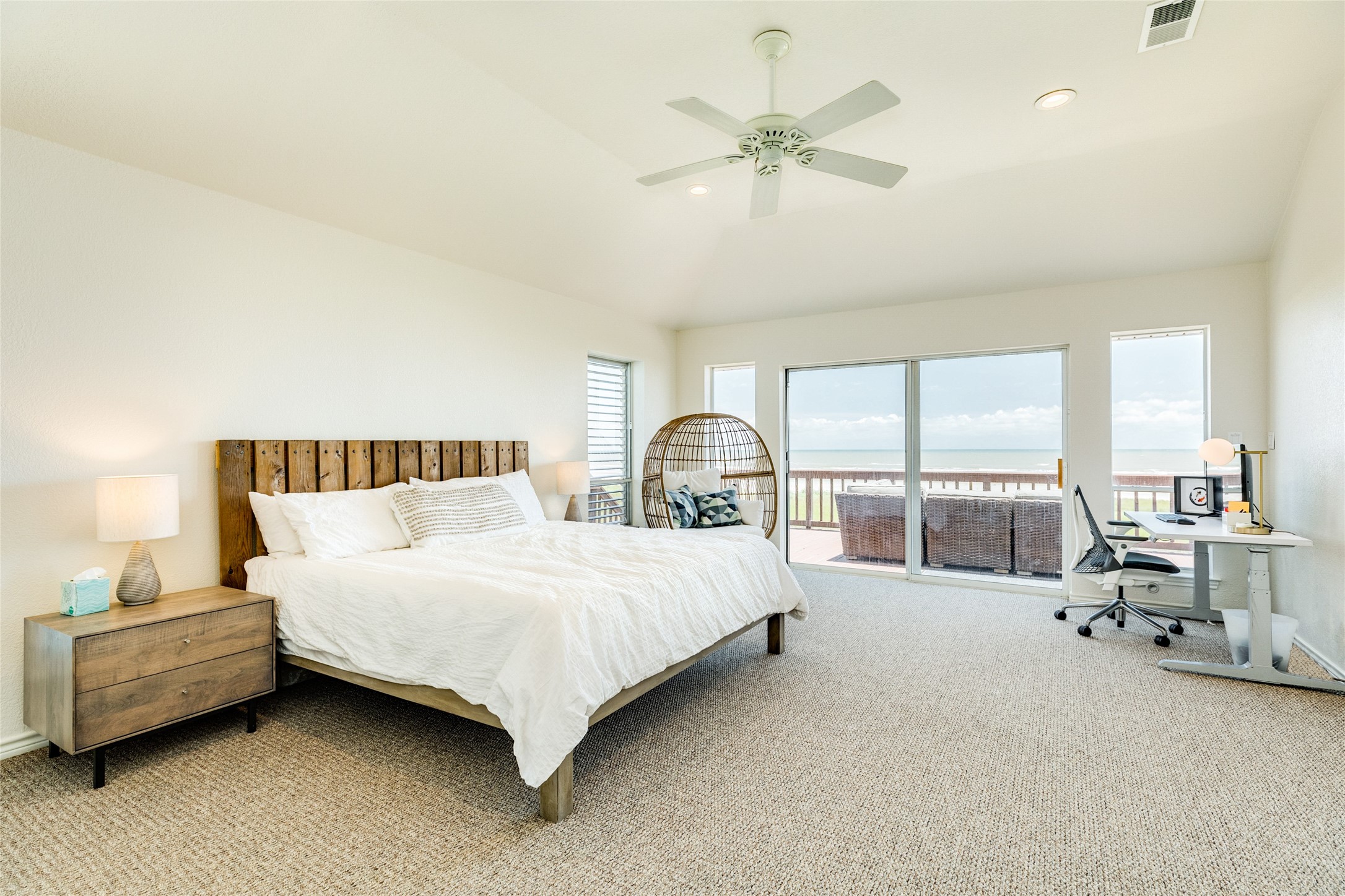 23331 Termini-San Luis Pass Road Galveston, TX 77554 - Photo 12 of 28 a spacious bedroom with a bed and large windows