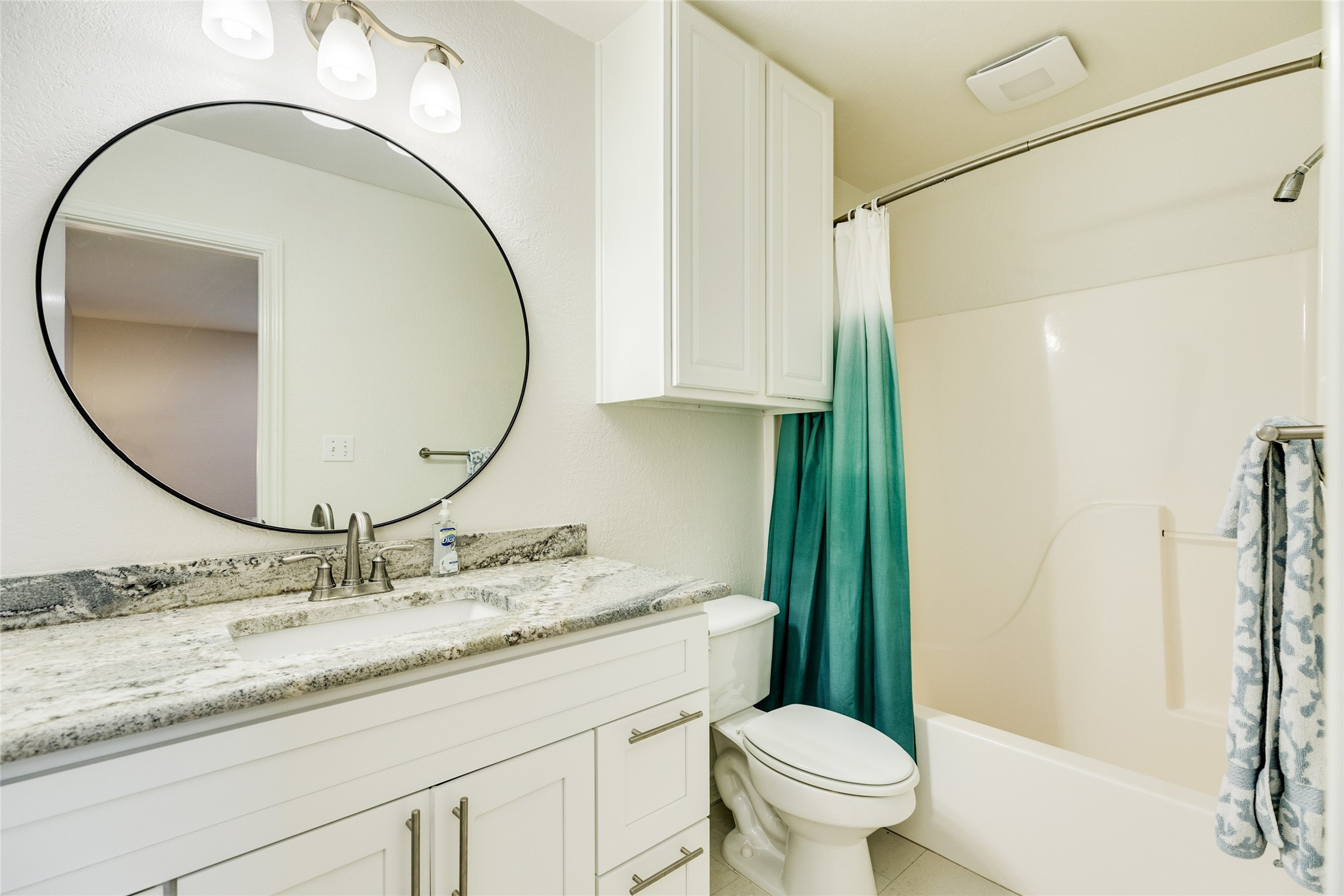 23331 Termini-San Luis Pass Road Galveston, TX 77554 - Photo 18 of 28 a bathroom with a granite countertop toilet a sink and a mirror