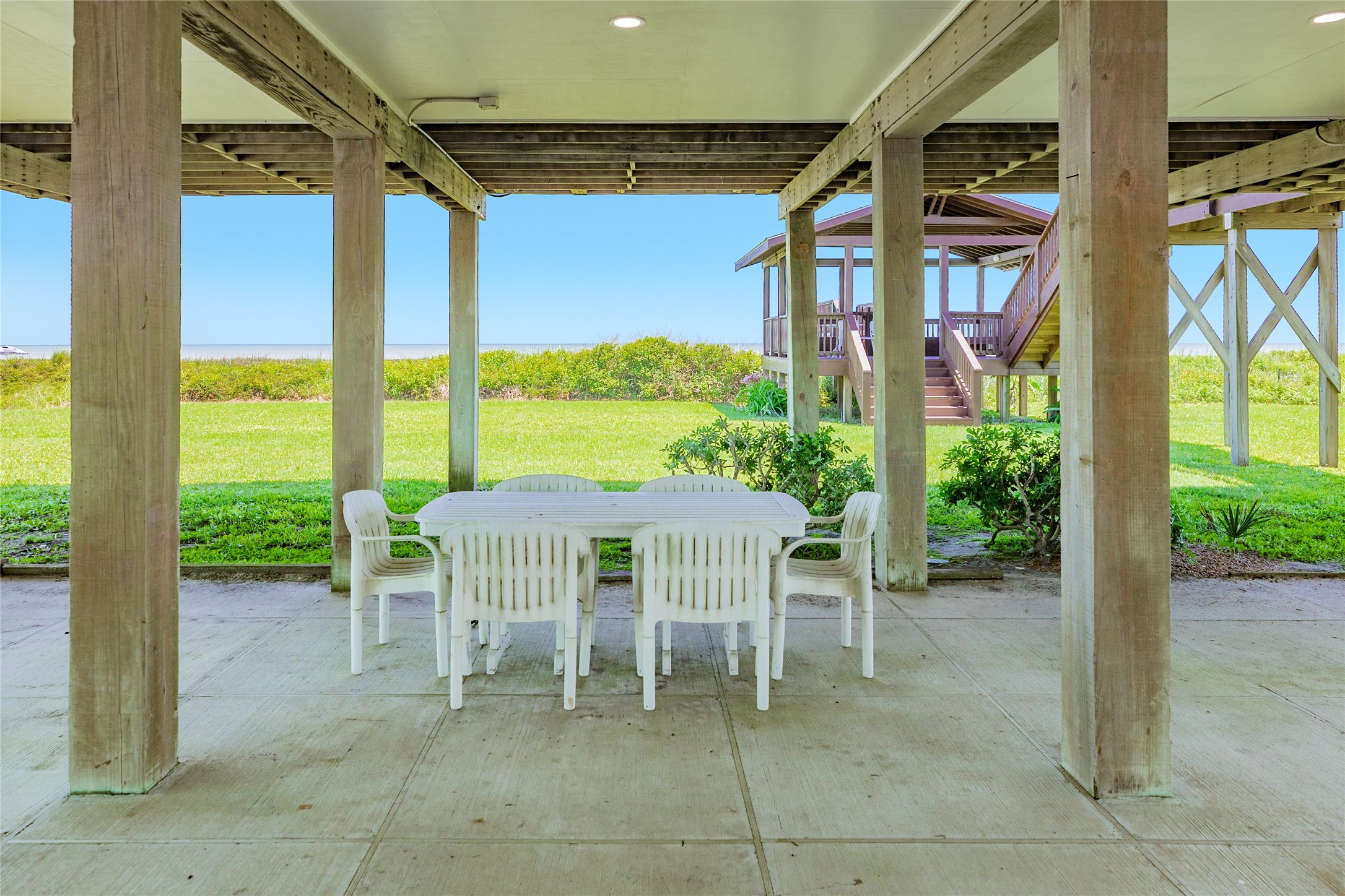 23331 Termini-San Luis Pass Road Galveston, TX 77554 - Photo 22 of 28 a patio with a table and chairs and potted plants