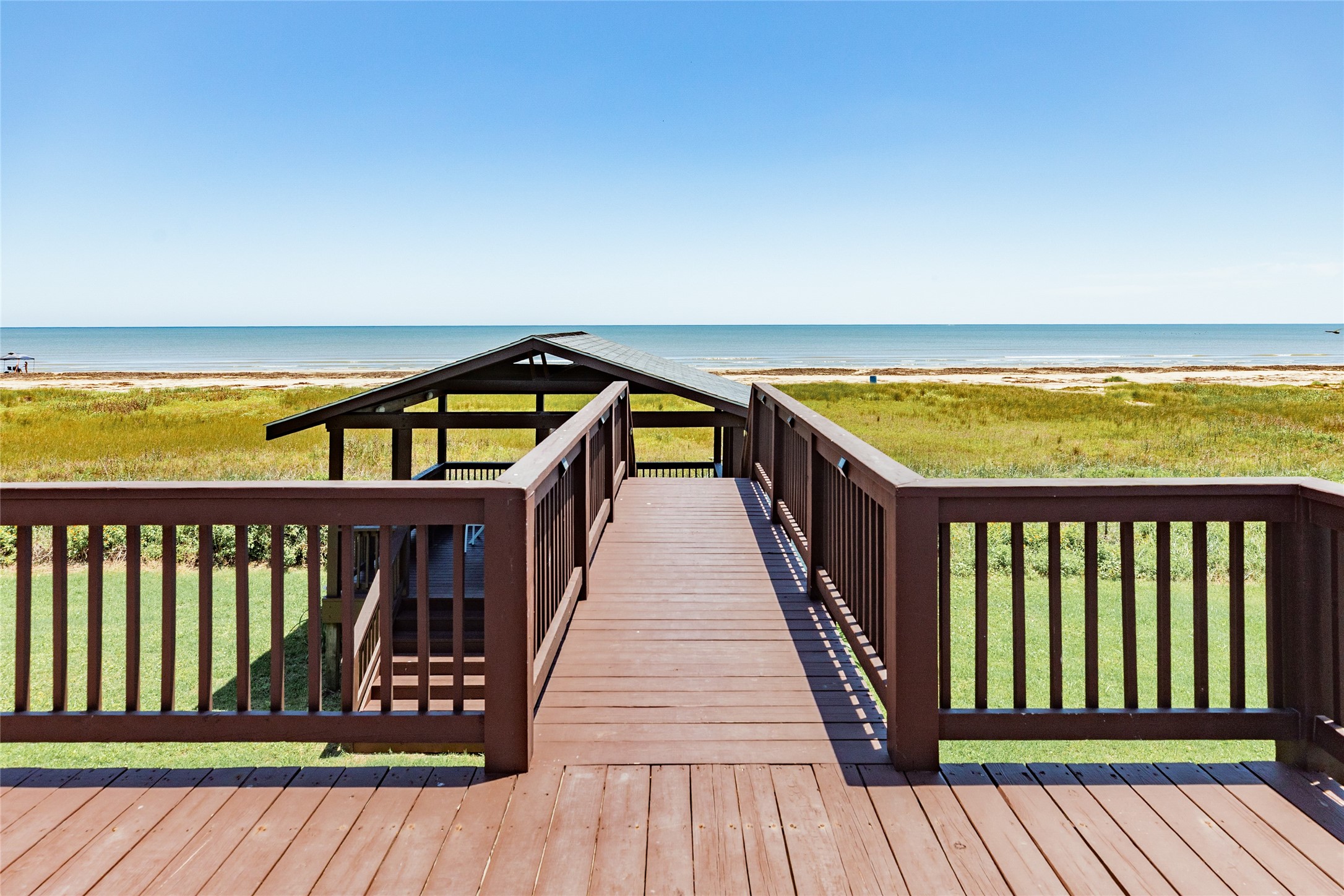23331 Termini-San Luis Pass Road Galveston, TX 77554 - Photo 24 of 28 a balcony with wooden floor and outdoor seating