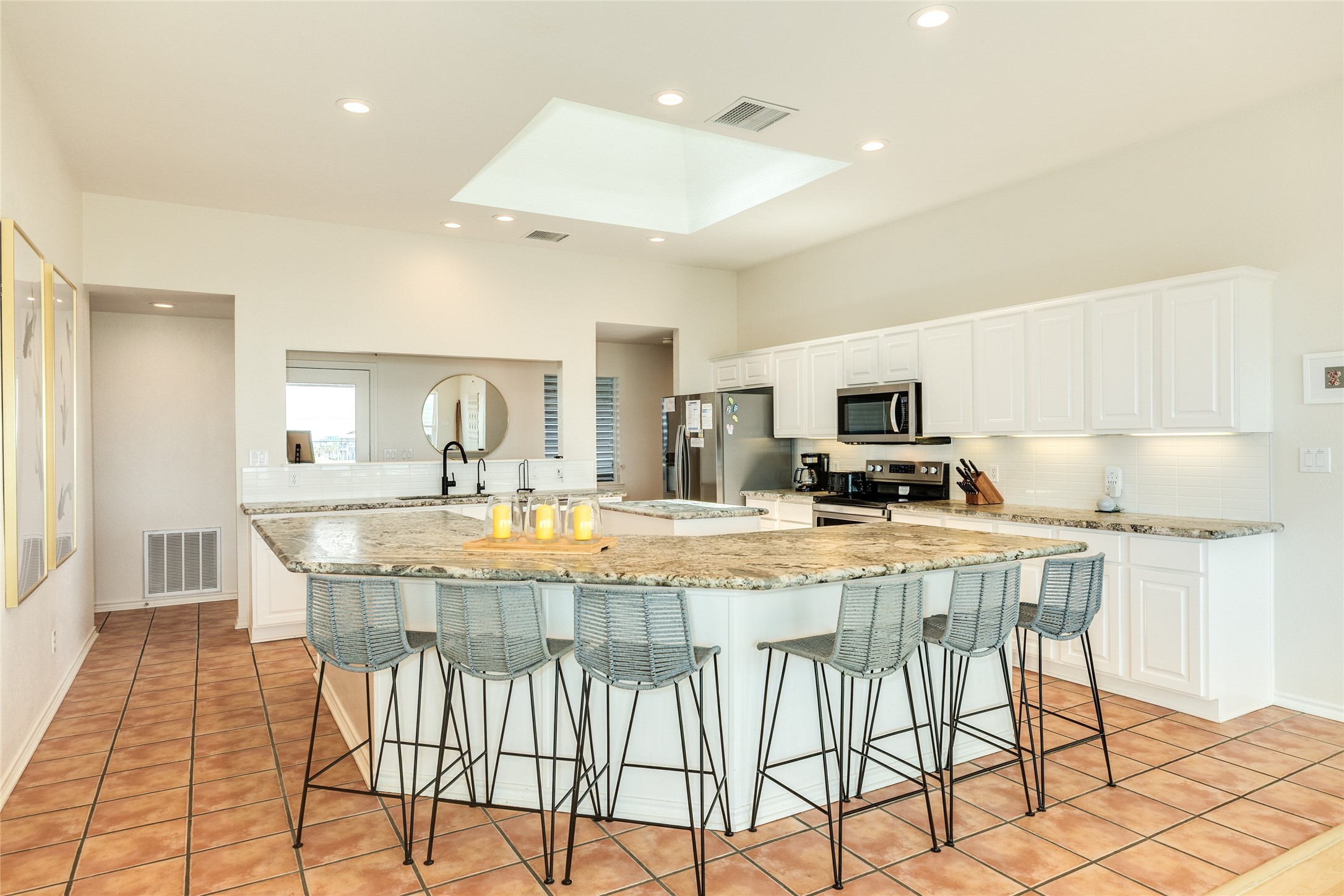 23331 Termini-San Luis Pass Road Galveston, TX 77554 - Photo 8 of 28 a kitchen with stainless steel appliances granite countertop a stove top oven a sink a dining table and chairs