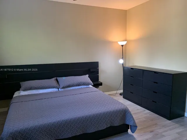 a bedroom with a bed and a dresser