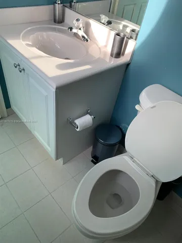 a bathroom with a granite shower and a toilet