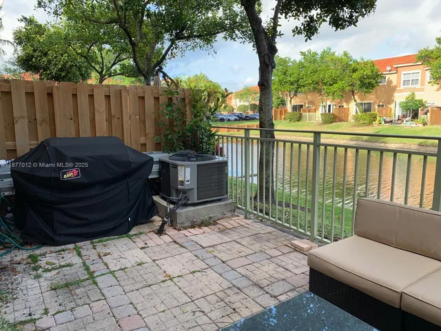 a view of a patio with couches next to a yard