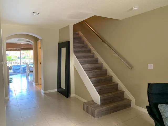 a view of a hallway with wooden floor and entryway