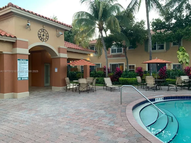 a view of a house with backyard sitting area and garden