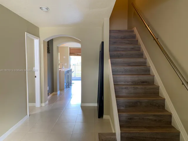 a living room with furniture a window and a chandelier