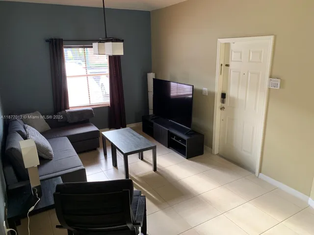 a kitchen with kitchen island a sink stove and refrigerator