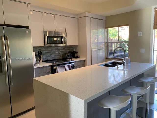 a view of a dining room with furniture wooden floor and a potted plant