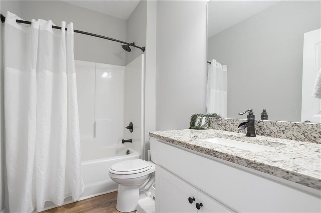 64 Neal Little Road Carnesville, GA 30521 - Photo 10 of 17 a bathroom with a granite countertop sink toilet and shower