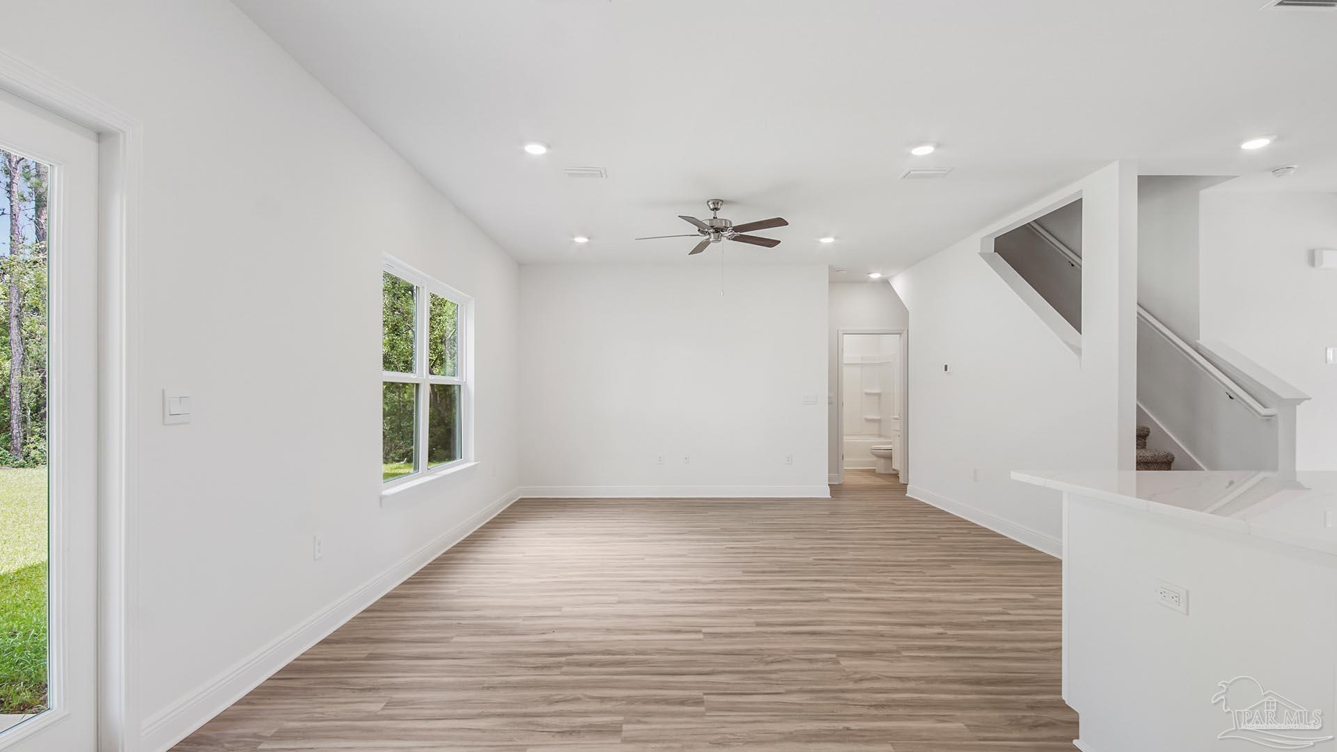 3233 Harrier Road Pace, FL 32571 - Photo 9 of 50 a view of an empty room with wooden floor and a window