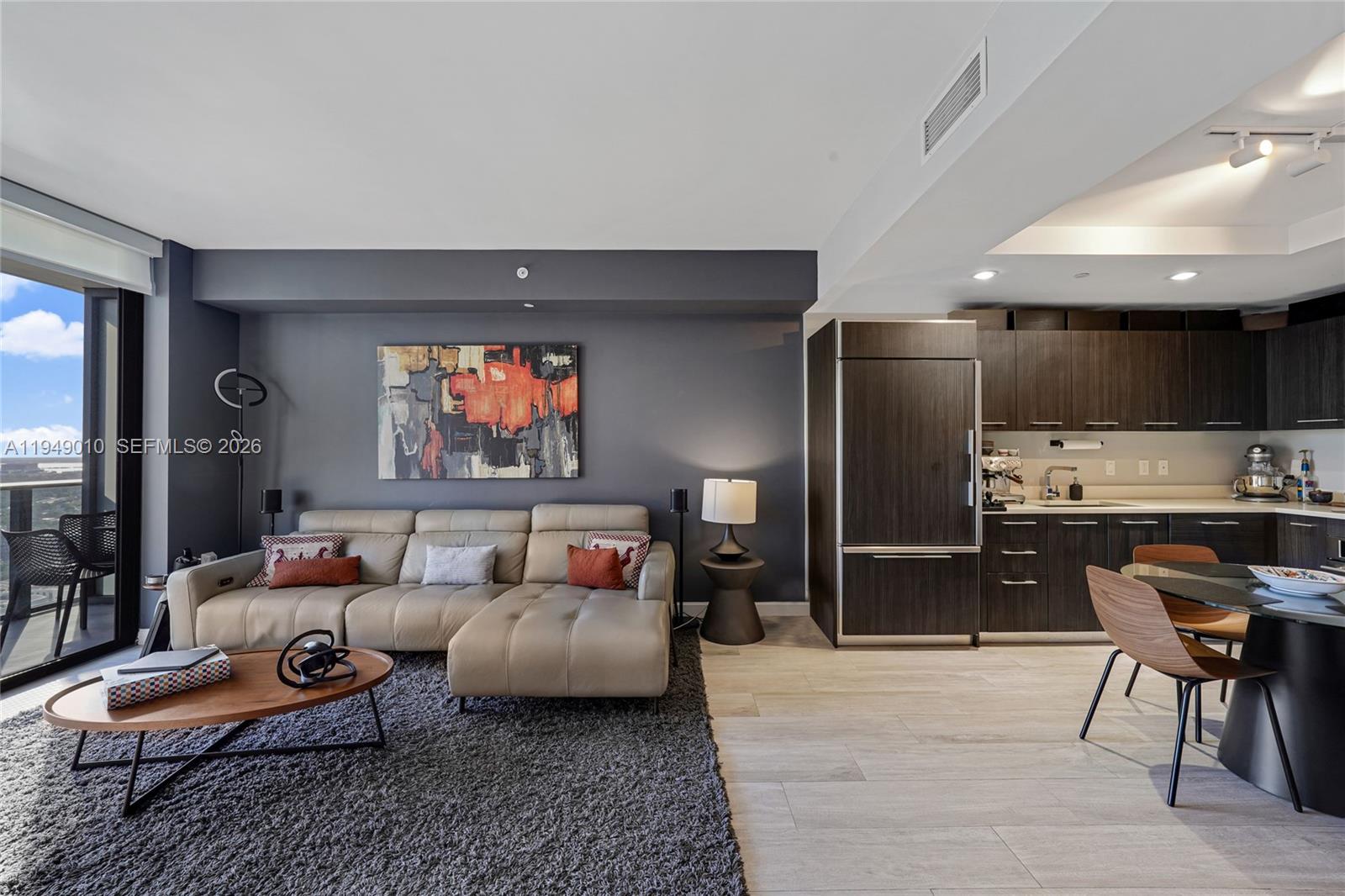 45 Southwest 9th Street, Unit 3405 Miami, FL 33130 - Photo 11 of 47 a living room with furniture and a flat screen tv