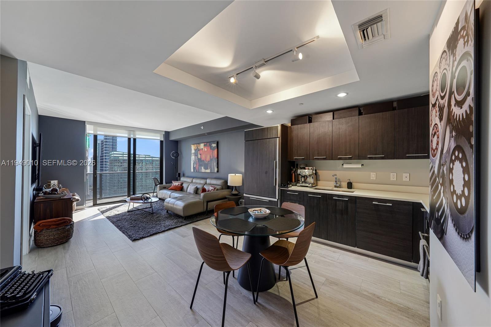 45 Southwest 9th Street, Unit 3405 Miami, FL 33130 - Photo 2 of 47 a living room with furniture and a flat screen tv