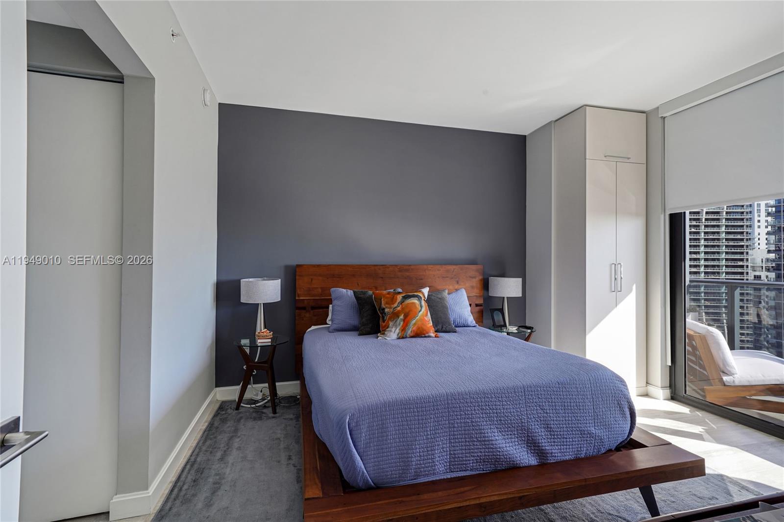 45 Southwest 9th Street, Unit 3405 Miami, FL 33130 - Photo 5 of 47 a bed room with a bed window and a chair