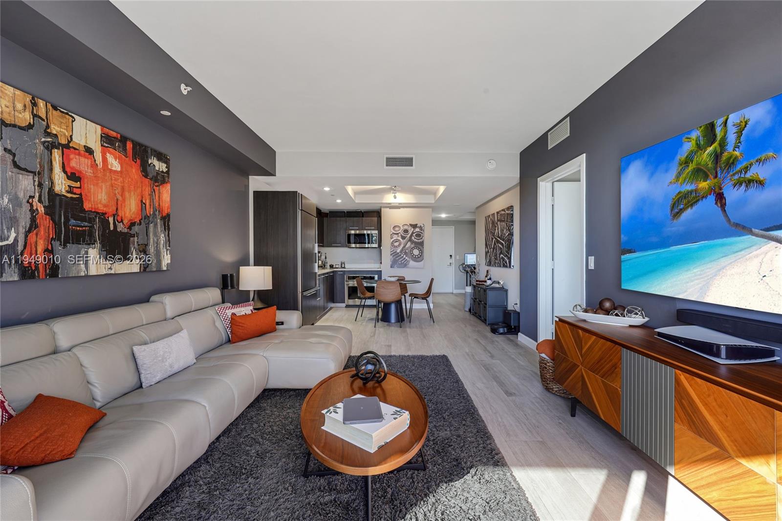 45 Southwest 9th Street, Unit 3405 Miami, FL 33130 - Photo 6 of 47 a living room with furniture and a flat screen tv