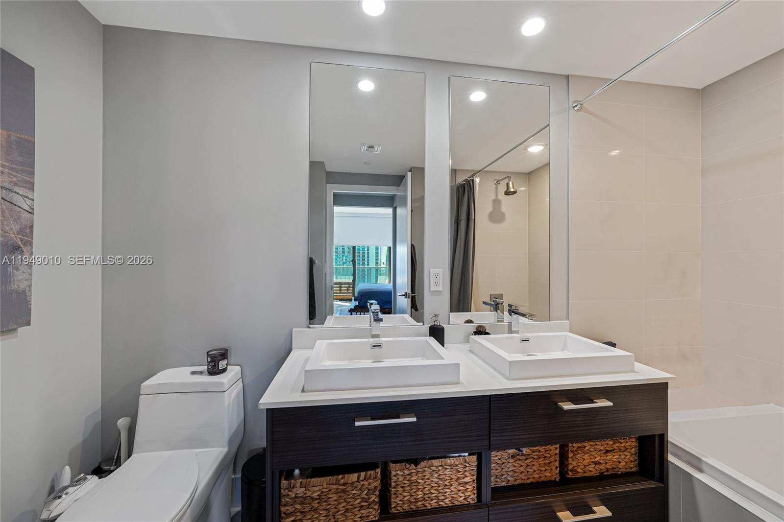 45 Southwest 9th Street, Unit 3405 Miami, FL 33130 - Photo 8 of 47 a bathroom with a sink and a mirror