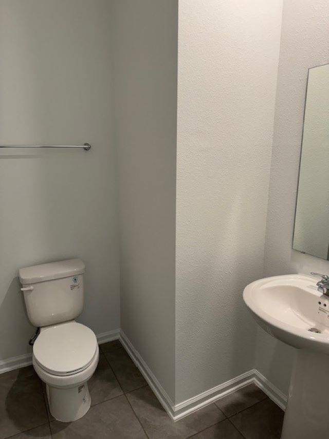 282 Redbud Road Palm Coast, FL 32137 - Photo 10 of 41 a white toilet sitting next to a bathroom sink