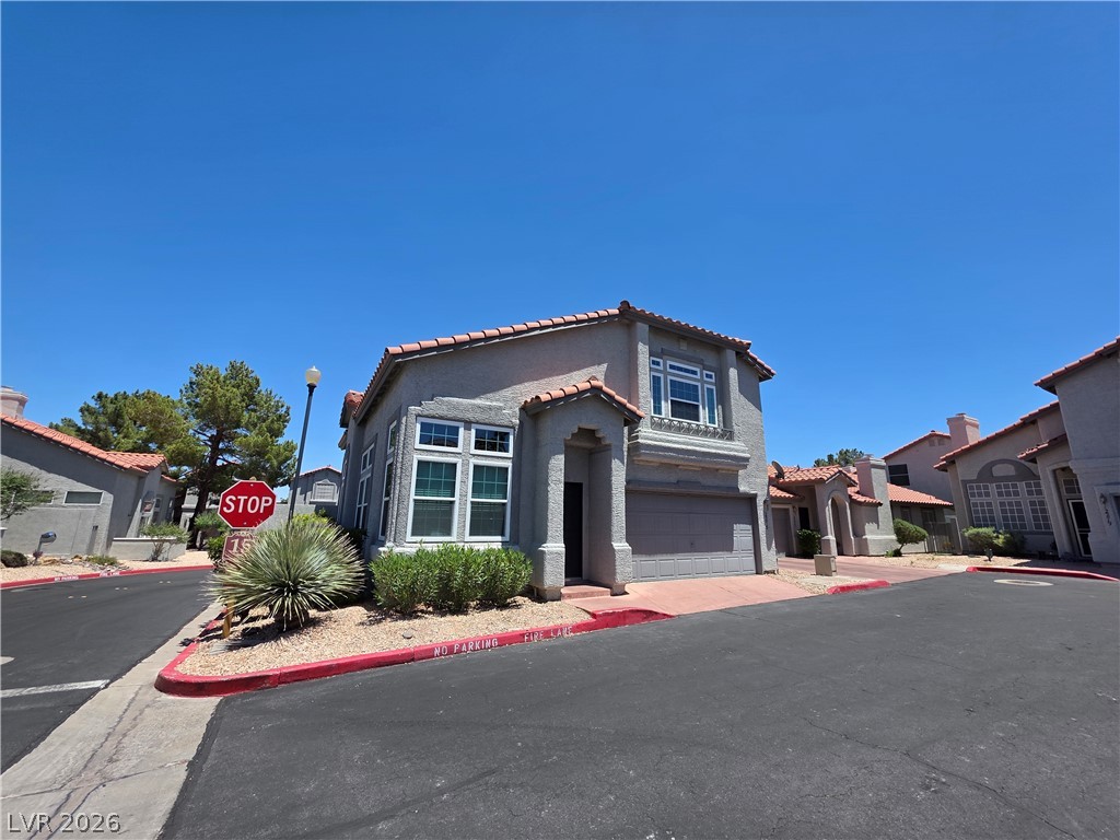 2275 Ramsgate Drive Henderson, NV 89074 - Photo 2 of 84 A terracotta-tiled roof and stucco exterior define this inviting suburban residence with an integrated garage.