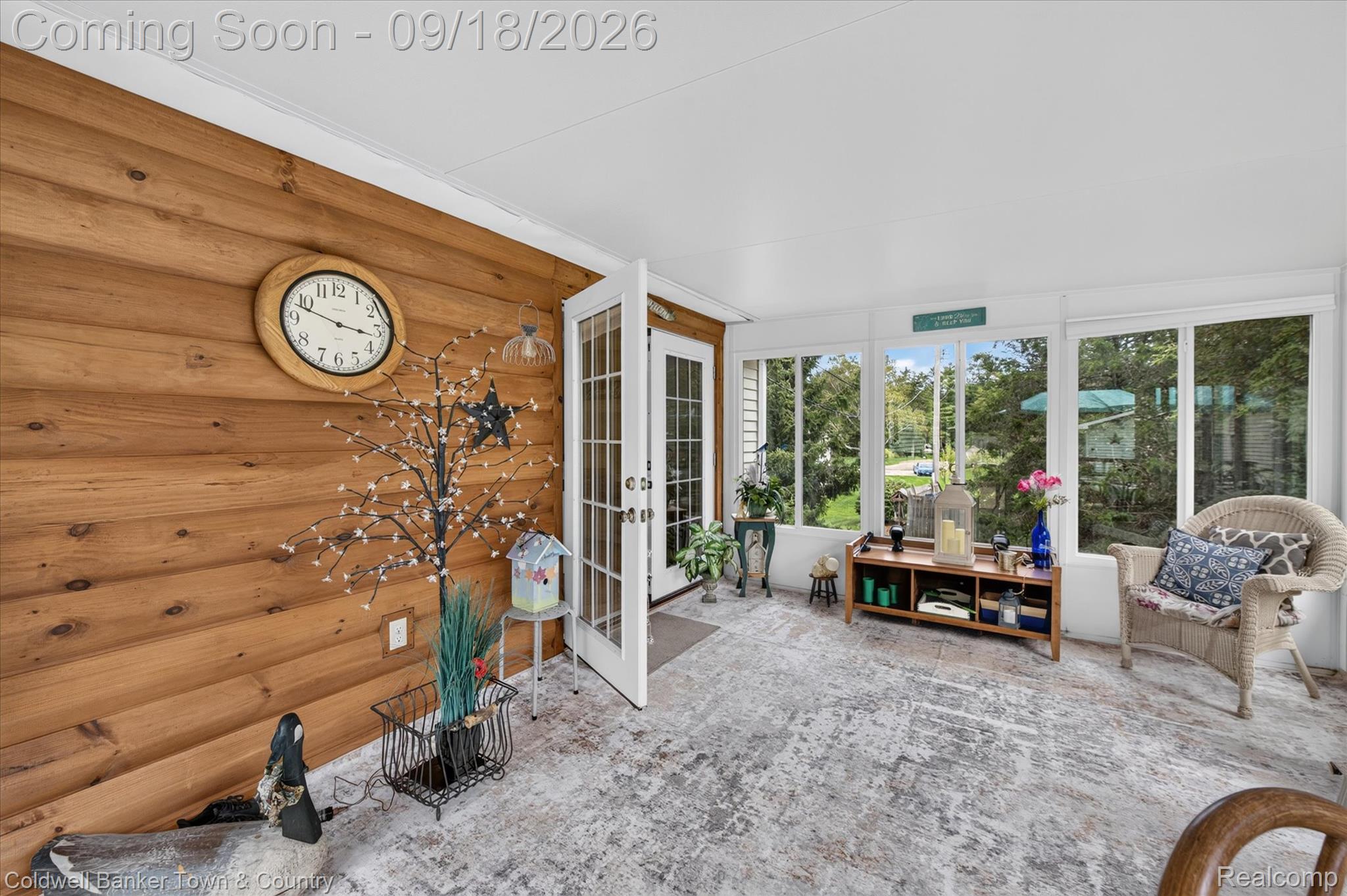 4442 McGunn Road Howell, MI 48843 - Photo 15 of 63 Wood-paneled wall, white ceiling, French doors, large windows, and light-toned flooring
