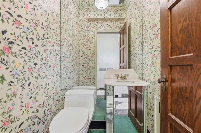 a bathroom with a toilet a sink and a shower curtain
