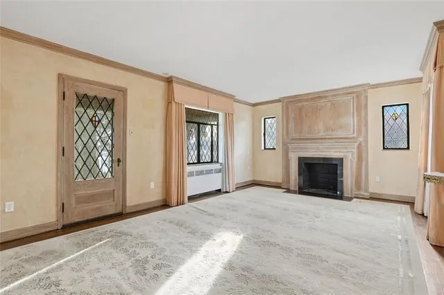 a view of a livingroom with an entryway and a fireplace