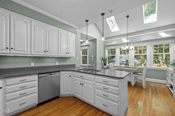 a kitchen with cabinets a sink and appliances