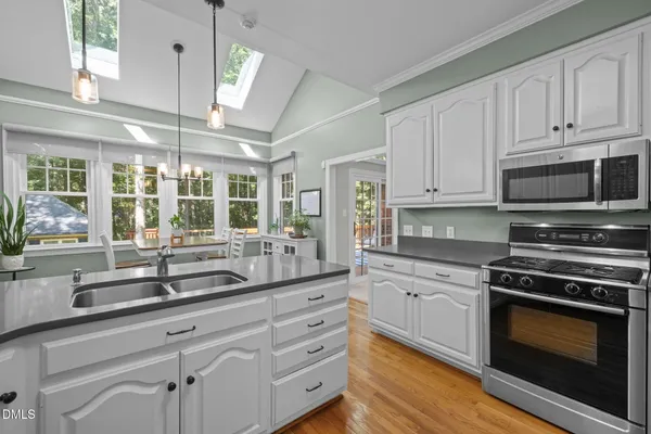 a kitchen with appliances a sink and cabinets