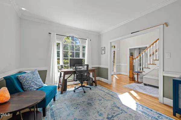 a bedroom with a bed and a couch next to a window