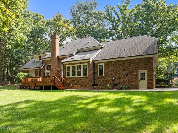 a view of a house with a yard and sitting area