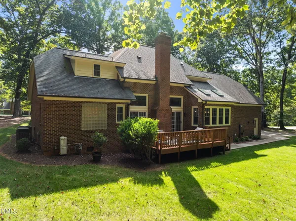 a view of a lush green forest with a street