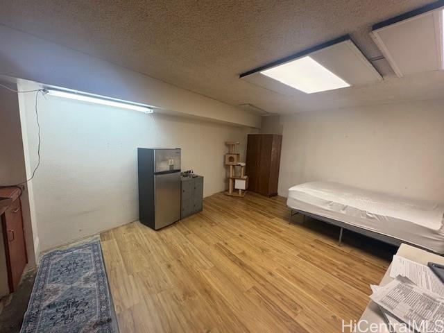 1750 Kalakaua Avenue, Unit 201 Honolulu, HI 96826 - Photo 3 of 6 a bedroom with a bed and wooden floor