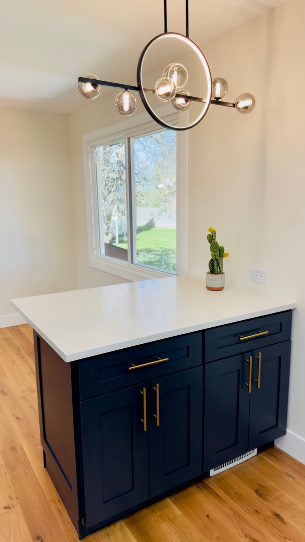 527 Northgate Road Lindenhurst, IL 60046 - Photo 12 of 35 a kitchen with a wooden floor and a large window