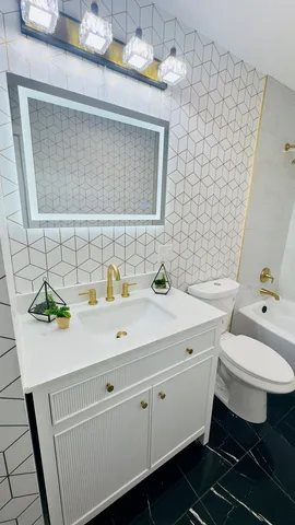 a bathroom with a sink toilet and shower