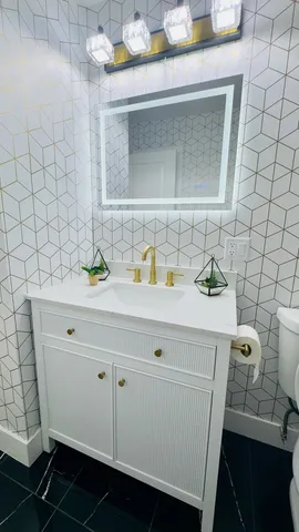 a bathroom with a sink and a mirror