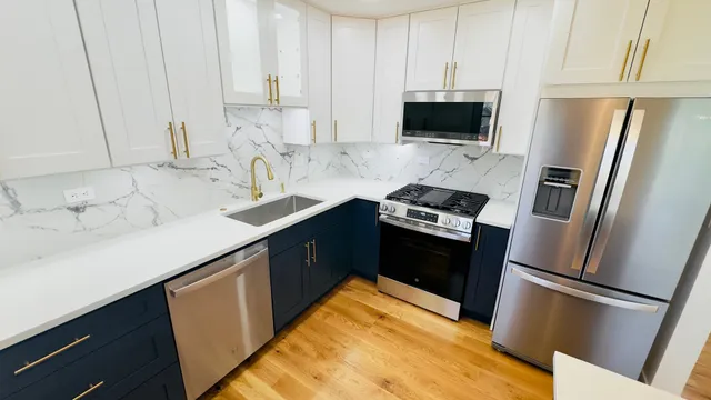 a kitchen with a sink appliances and cabinets