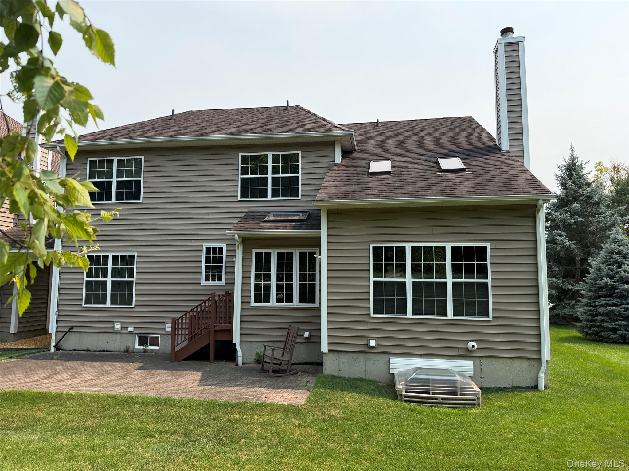 415 Vassar Place Fishkill, NY 12524 - Photo 2 of 4 Rear view of home with stone patio