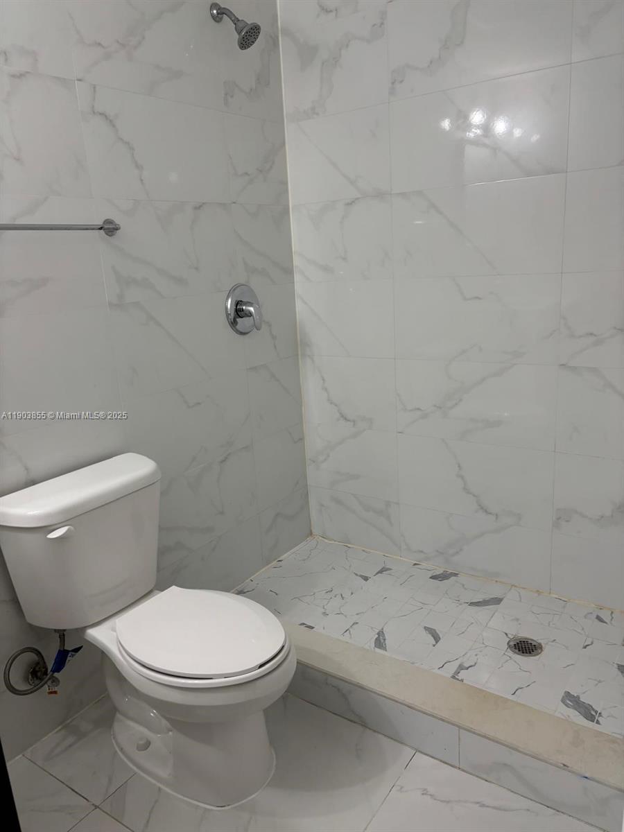 423 East 27th Street, Unit 101 Hialeah, FL 33013 - Photo 11 of 13 a bathroom with a toilet and a shower