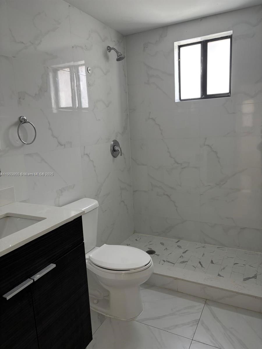 423 East 27th Street, Unit 101 Hialeah, FL 33013 - Photo 4 of 13 a bathroom with a toilet a sink and shower