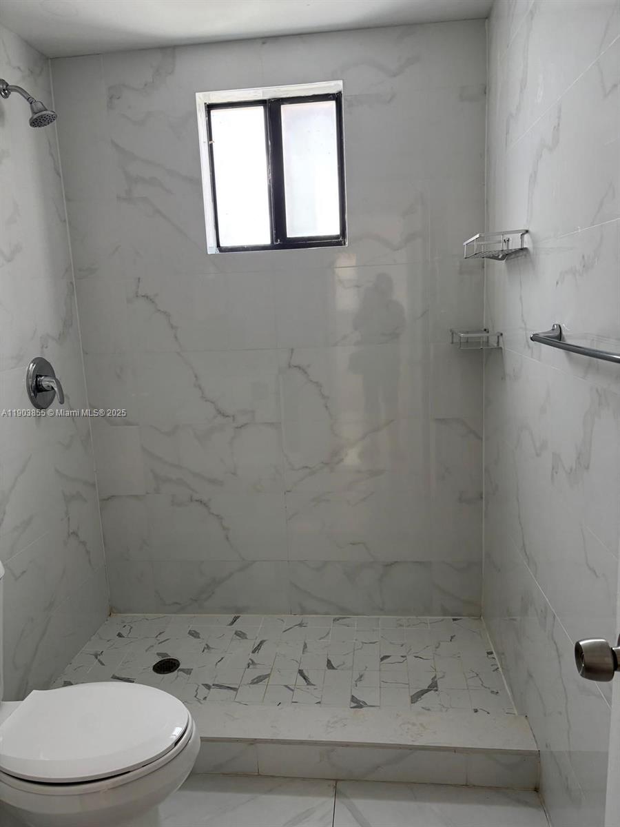 423 East 27th Street, Unit 101 Hialeah, FL 33013 - Photo 7 of 13 a bathroom with a toilet and a shower