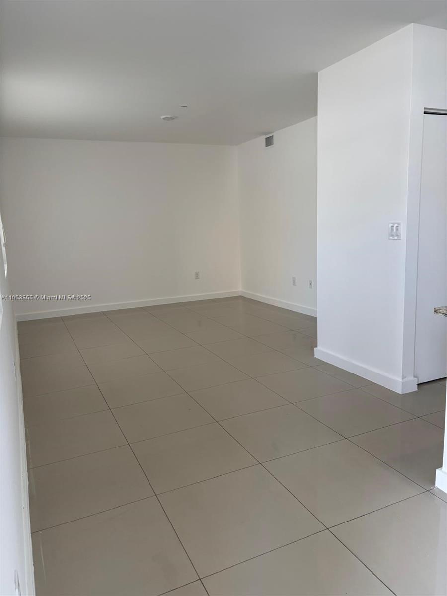 423 East 27th Street, Unit 101 Hialeah, FL 33013 - Photo 9 of 13 an empty room with a bench