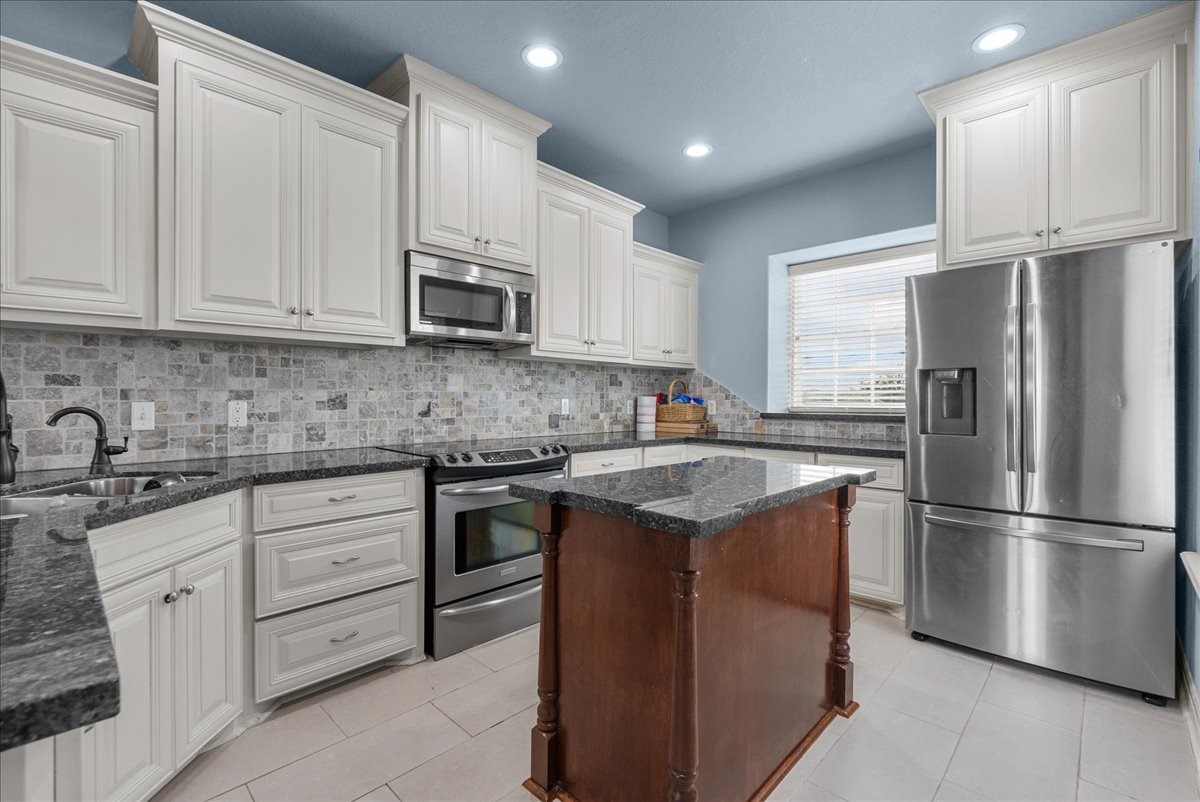 211 Tuna Run Freeport, TX 77541 - Photo 17 of 48 This spacious kitchen boasts ample storage, granite countertops and stainless steel appliances.