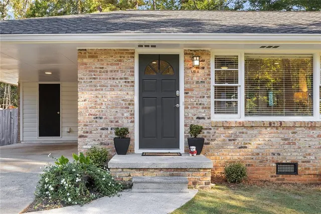 front view of a brick house with a large window