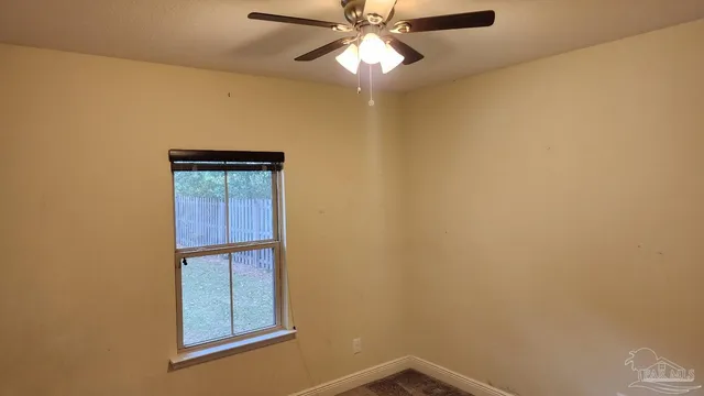 a view of a room with a window and a fan