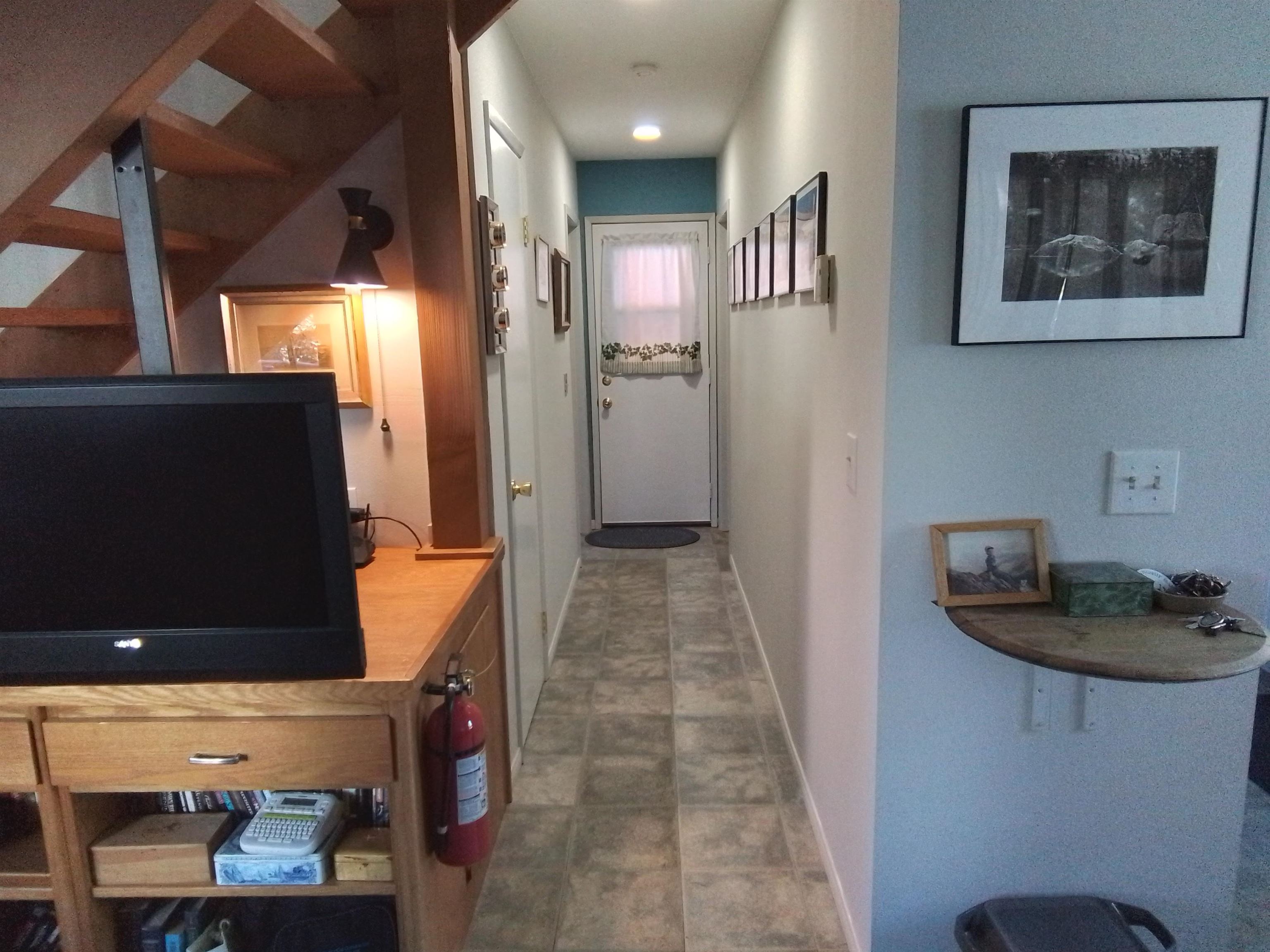 199 Hunewill Drive Bridgeport, CA 93517 - Photo 13 of 40 Hallway featuring tile flooring and recessed lighting, with an adjacent open-riser staircase