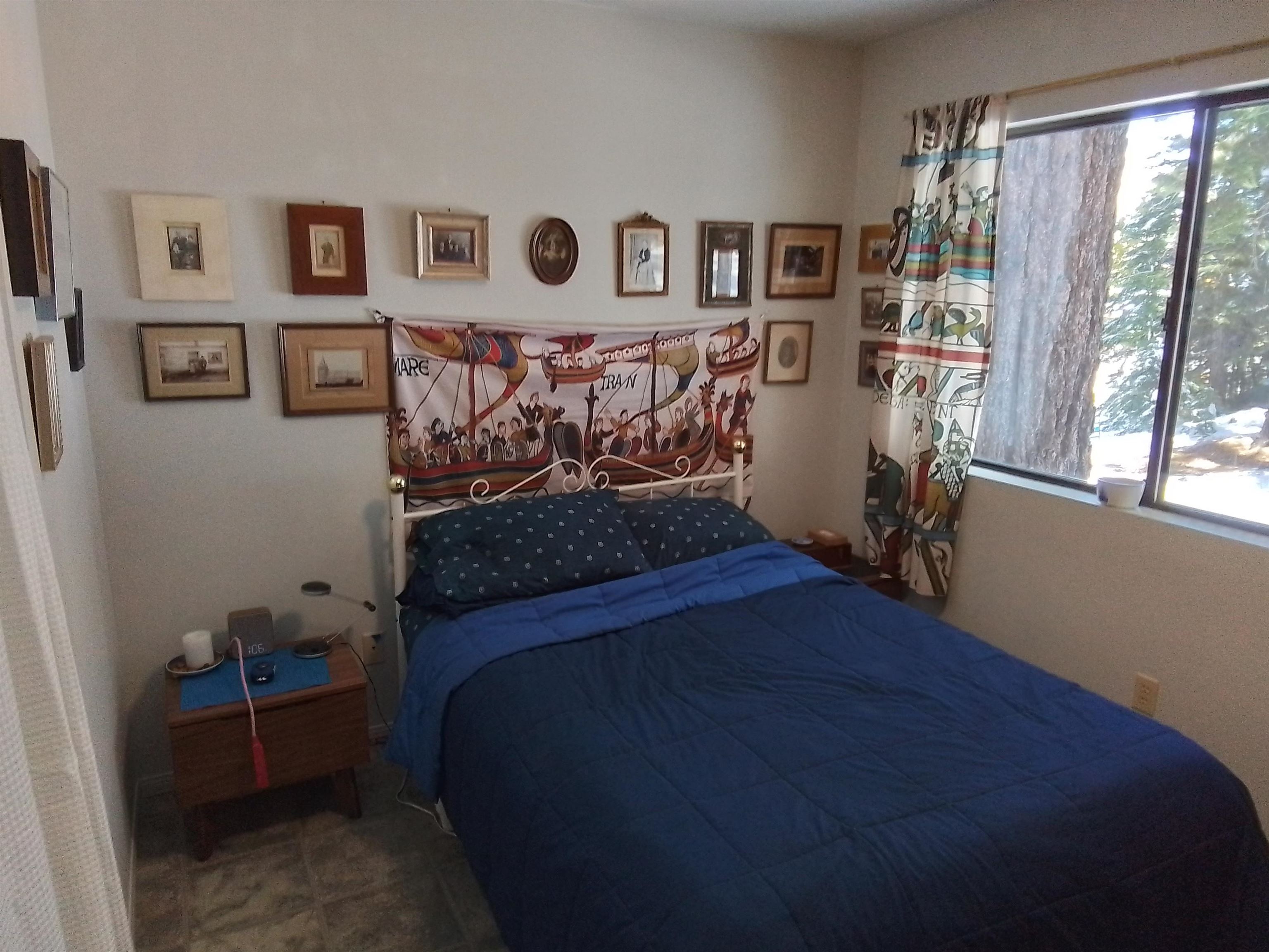 199 Hunewill Drive Bridgeport, CA 93517 - Photo 16 of 40 Bright room featuring a large window, tiled flooring, and white painted walls