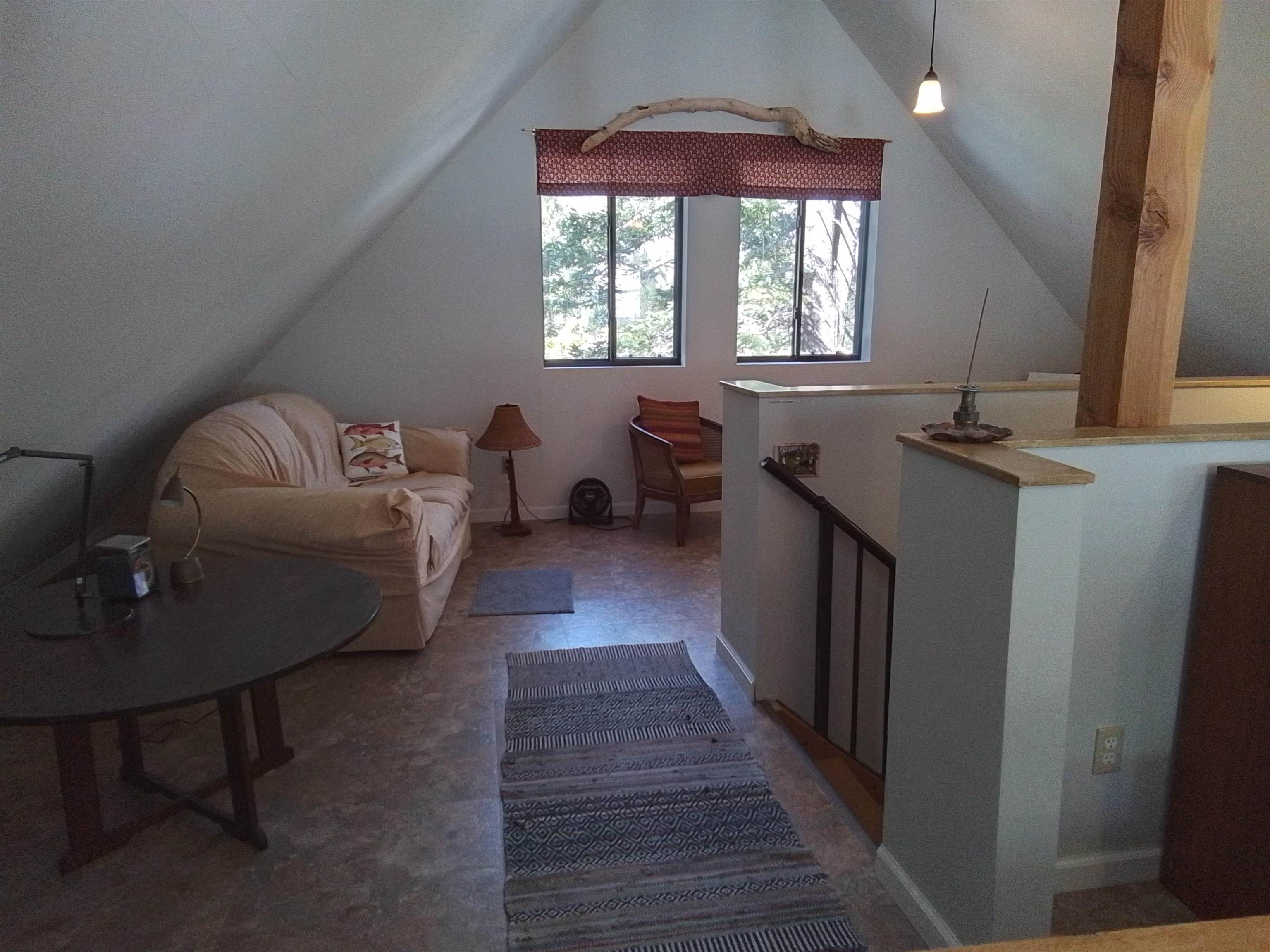 199 Hunewill Drive Bridgeport, CA 93517 - Photo 18 of 40 Vaulted ceiling accentuates this open space featuring two large windows, exposed wood beams, and an