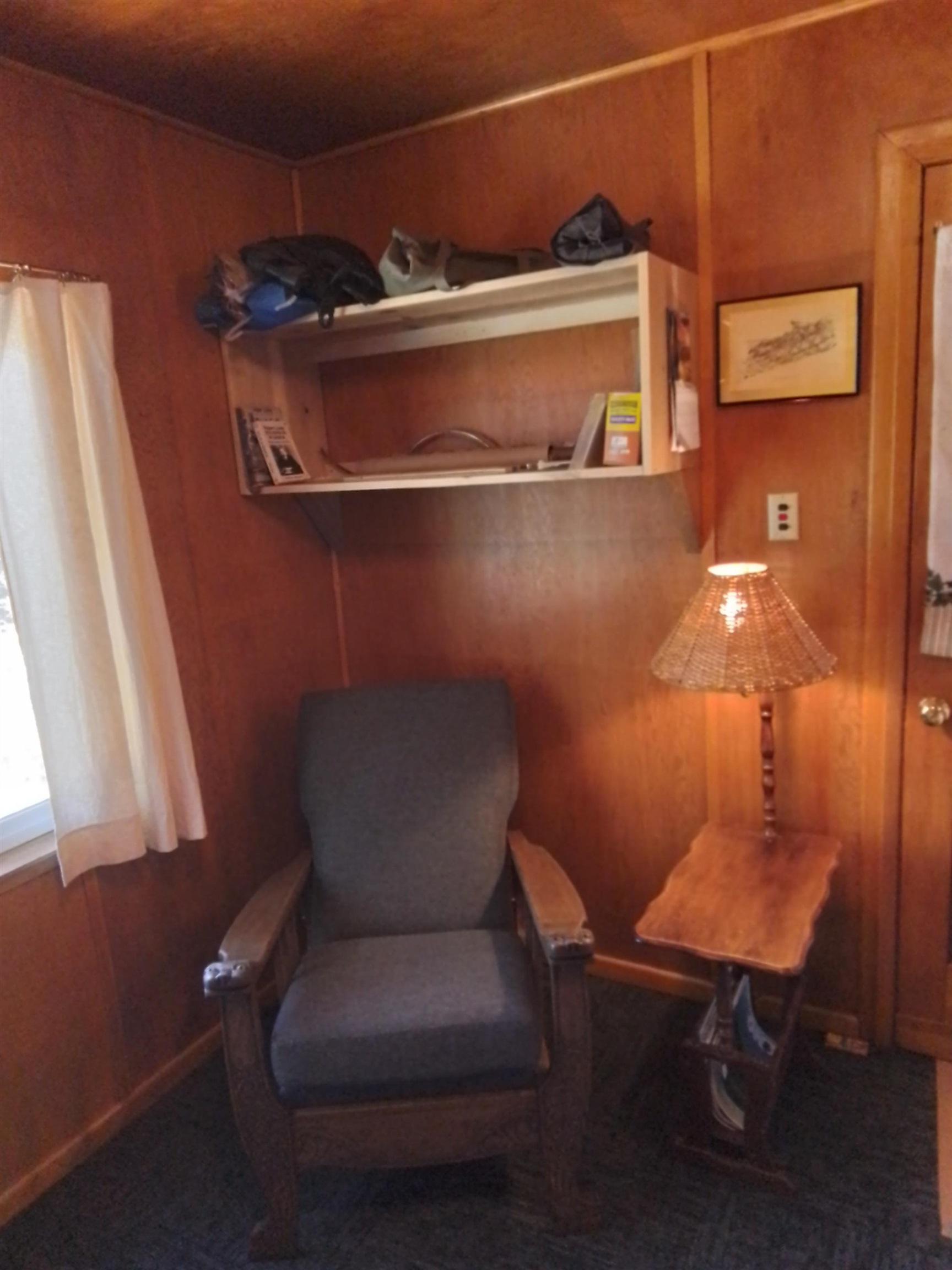 199 Hunewill Drive Bridgeport, CA 93517 - Photo 25 of 40 Vertical wood paneling walls with a built-in shelving unit, carpeted flooring, and a single window w