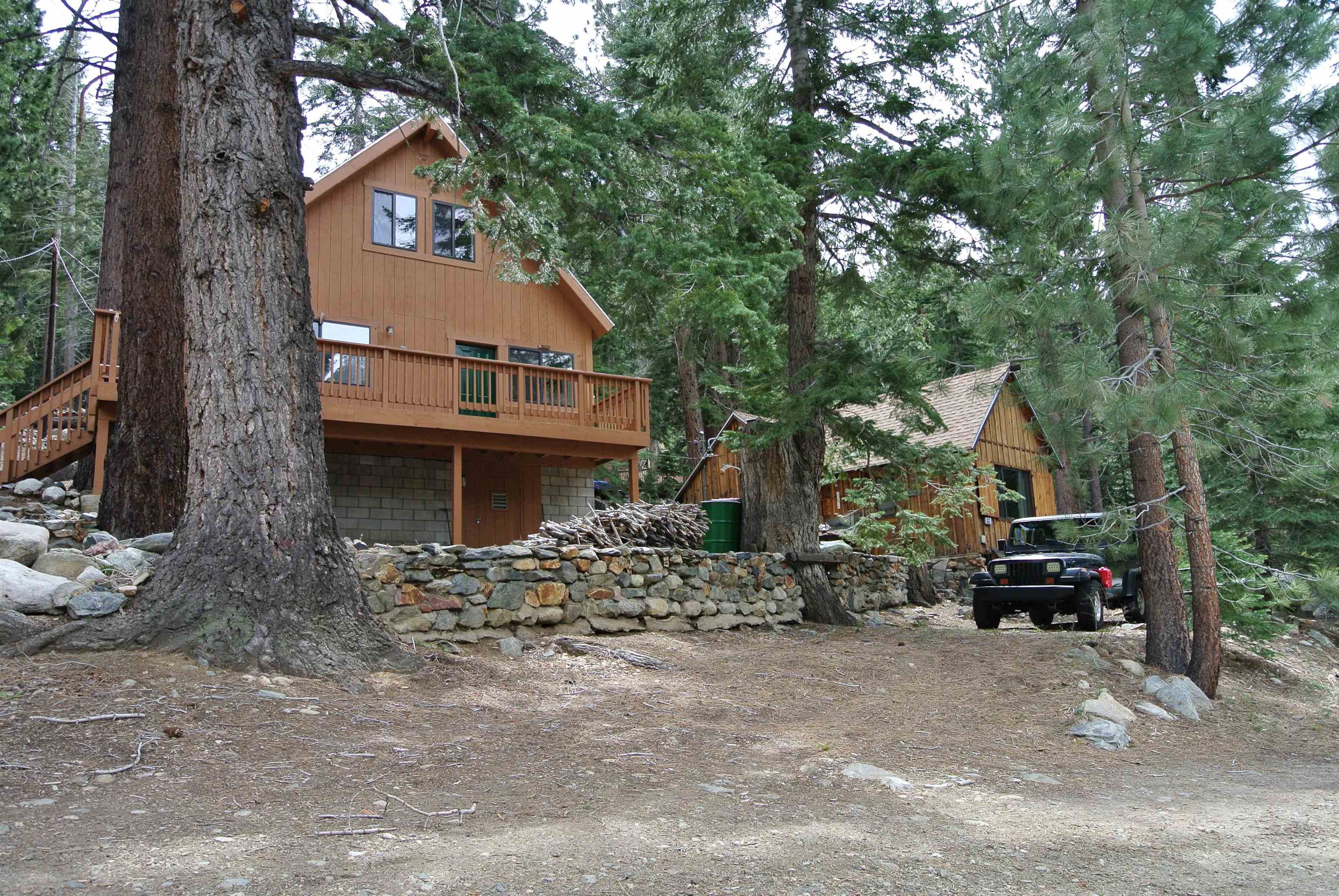 199 Hunewill Drive Bridgeport, CA 93517 - Photo 26 of 40 Two-story wood-sided property featuring an elevated deck with a wood railing and staircase