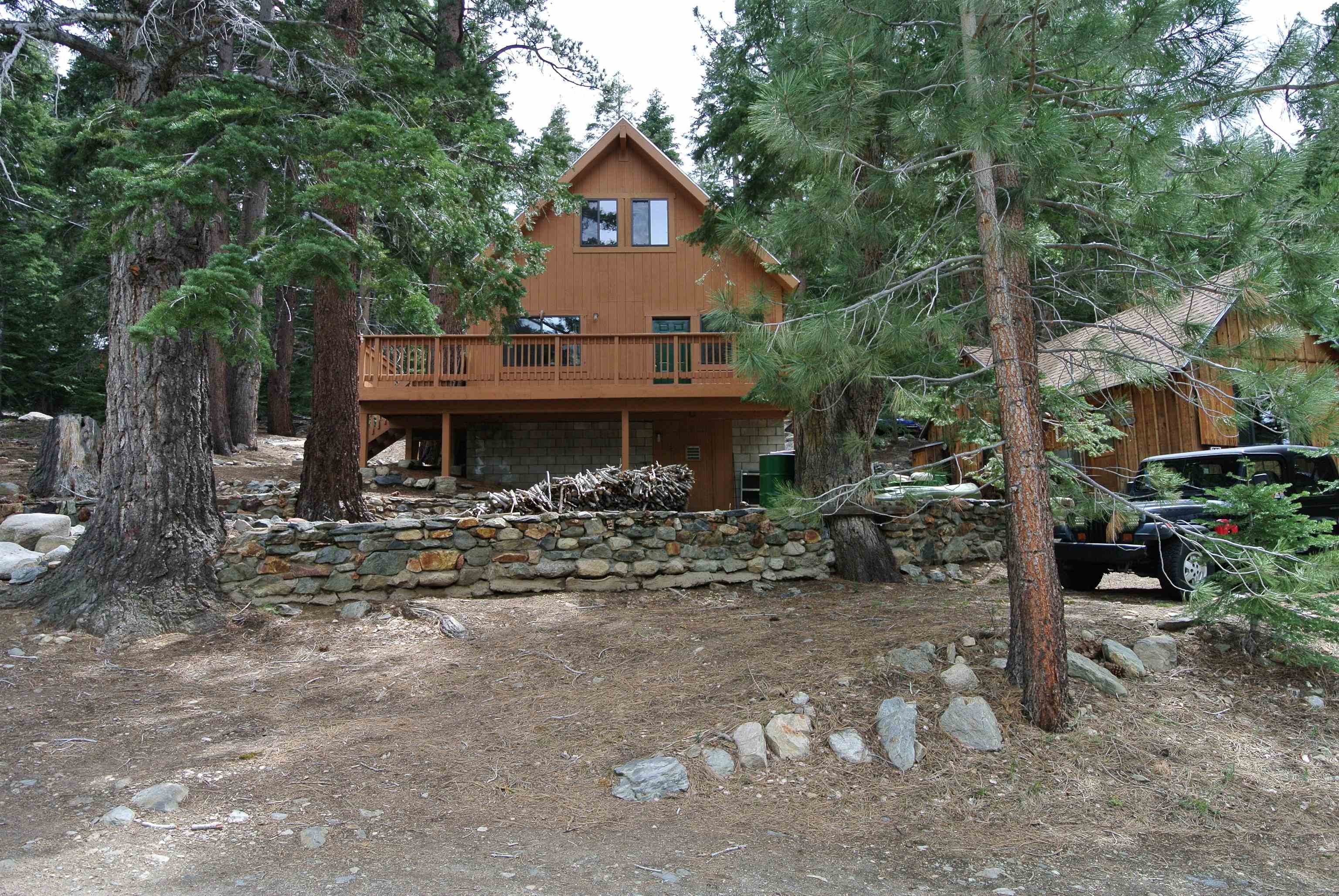 199 Hunewill Drive Bridgeport, CA 93517 - Photo 32 of 40 Rustic-style home featuring a prominent upper-level deck, a natural wood-tone exterior, and an A-fra